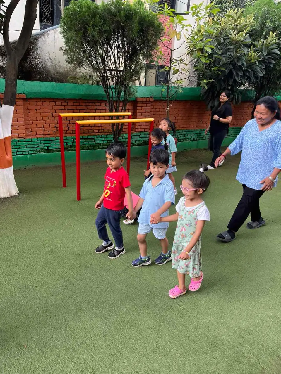 A group of friends walking while holding hands.