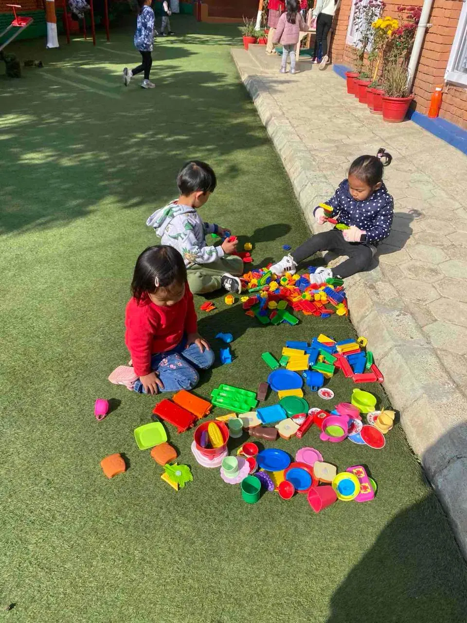 Children playing with toys on Mother Care's premises.