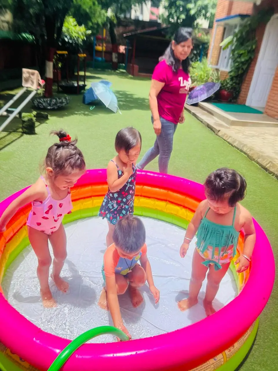 Children swimming in a small pool.